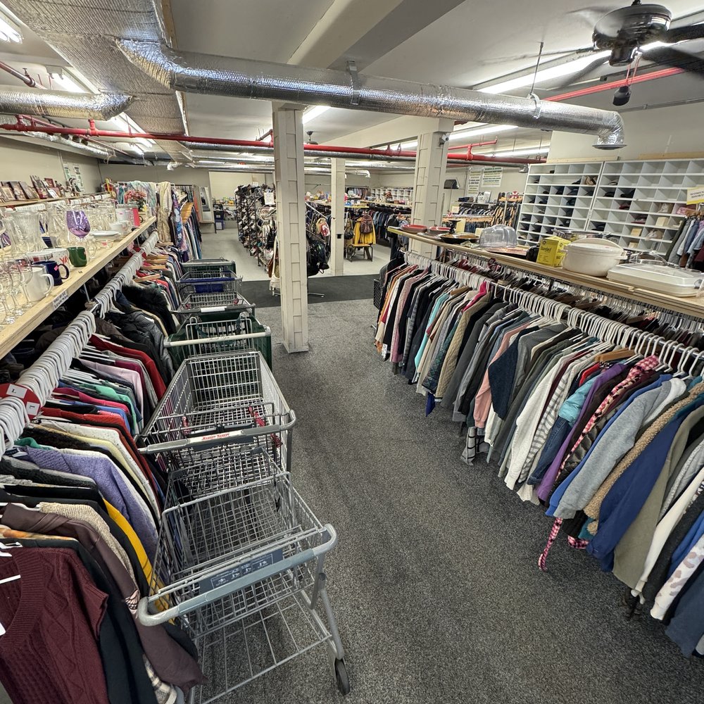 Clothing racks down the main aisle at Mass Value Thrift Store