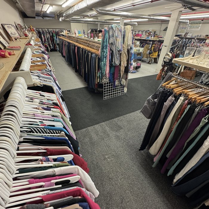 Close-up of a colorful clothing rack at Mass Value Thrift Store