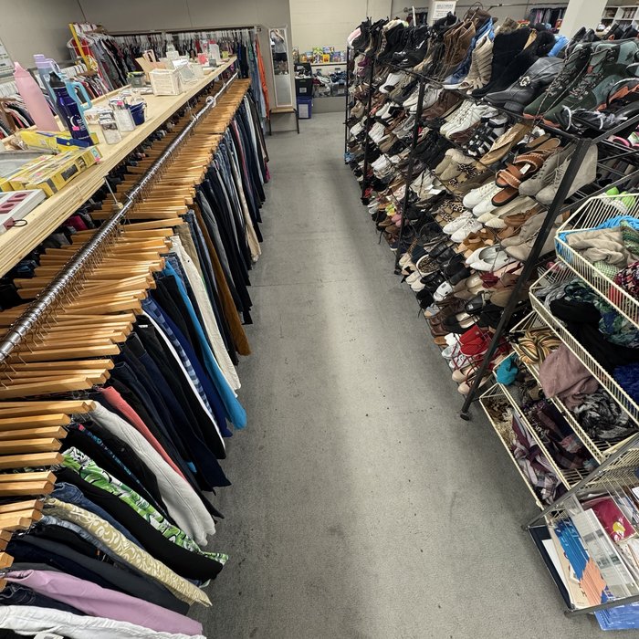 Wall of shoes organized by style at Mass Value Thrift Store